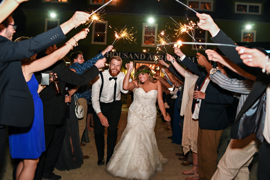 A sparkler send off of a newly married couple at thousand acre farm.